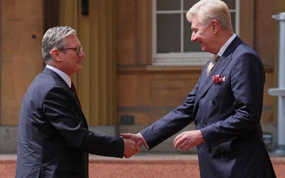 Sir Keir Starmer is greeted by Sir Clive Alderton, Principal Private Secretary to the King and Queen, as he arrives for an audience with His Majesty