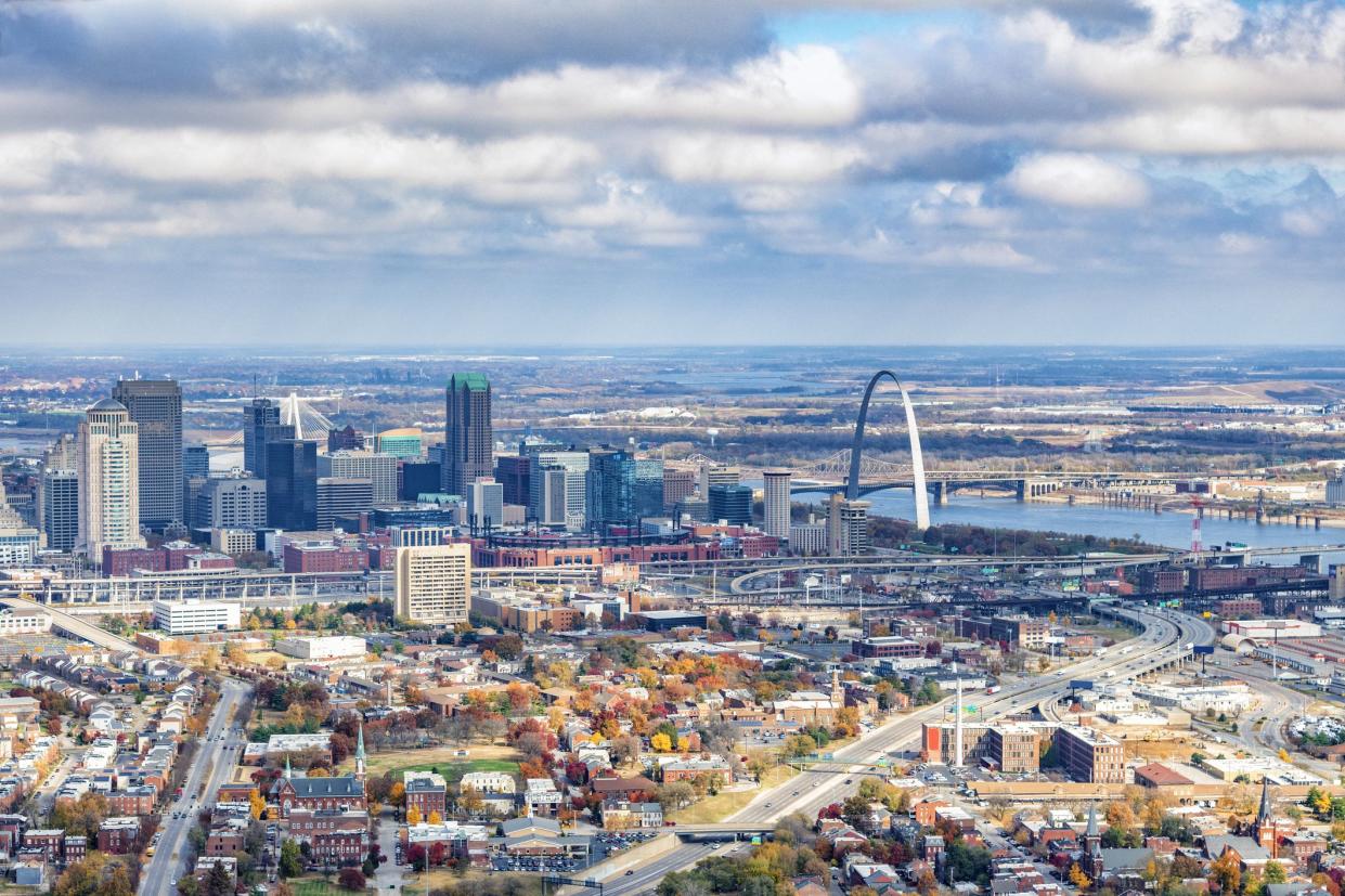 The skyline of St. Louis, Missouri along the banks of the Mississippi River shot from a distance at an altitude of about 1000 feet.