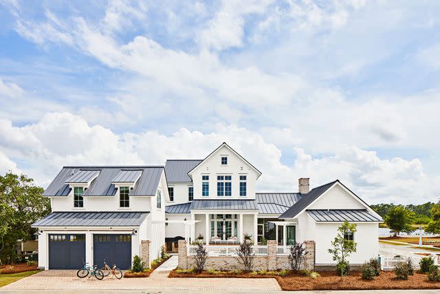 PHOTOGRAPHY BY LAUREY W. GLENN; STYLING BY KENDRA SURFACE The garage features Clopay Canyon Ridge Louver insulated doors that deliver nautical vibes with a coat of Sherwin-Williams’ Charcoal Blue (SW 2739).