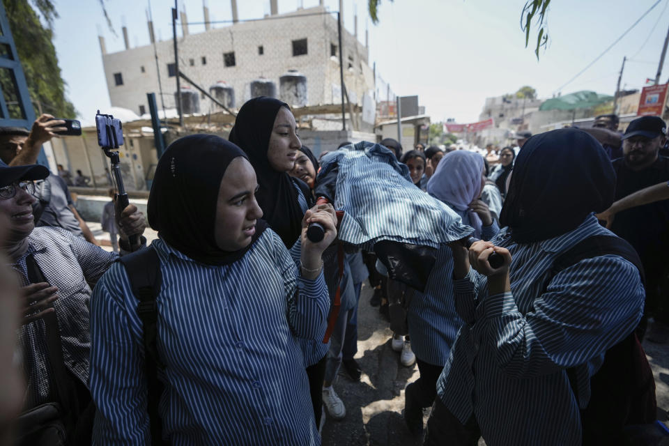 The classmates of 15-year-old Sadeel Naghniyeh carry her body during her funeral in the West Bank Jenin refugee camp, Wednesday, June 21, 2023, Naghniyeh died from wounds sustained in an Israeli military raid on Monday that triggered some of the fiercest fighting with Palestinian militants in years. (AP Photo/Majdi Mohammed)