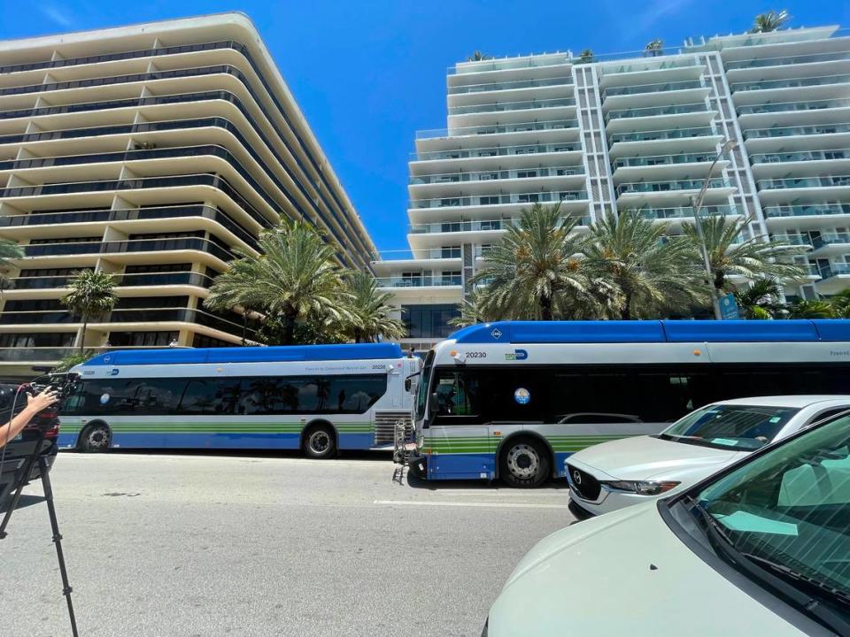 Miami-Dade County buses wait to ferry loved ones from the reunification center at the Grand Beach Hotel in Surfside to the site of the Champlain Towers South condo collapse.