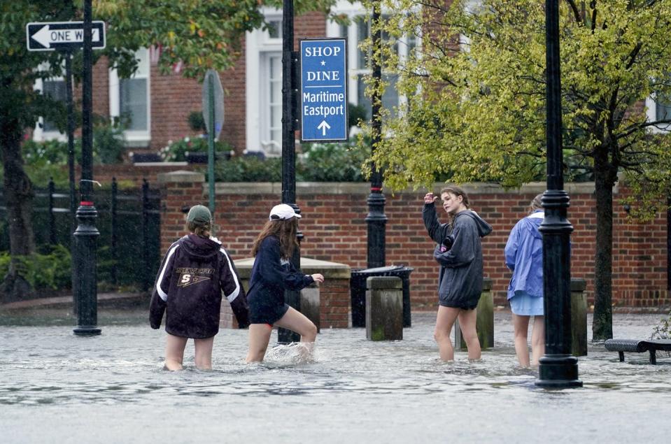 <span class="caption">People walked down a flood sidewalk in Annapolis, Maryland, on Oct. 29, 2021.</span> <span class="attribution"><a class="link " href="https://newsroom.ap.org/detail/SevereWeather/7ca9566680a5453d9ed0dca4e75a06ce/photo" rel="nofollow noopener" target="_blank" data-ylk="slk:AP Photo/Susan Walsh;elm:context_link;itc:0;sec:content-canvas">AP Photo/Susan Walsh</a></span>