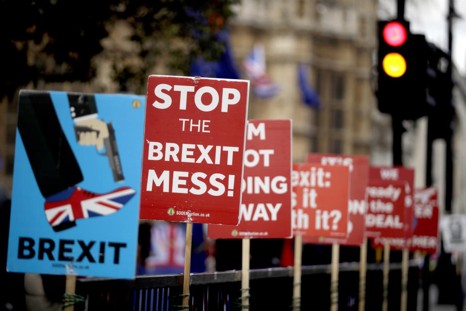 Placards placed by anti-Brexit supporters stand opposite the Houses of Parliament in London, Monday, March 18, 2019. British Prime Minister Theresa May was making a last-minute push Monday to win support for her European Union divorce deal, warning opponents that failure to approve it would mean a long — and possibly indefinite — delay to Brexit. Parliament has rejected the agreement twice, but May aims to try a third time this week if she can persuade enough lawmakers to change their minds. (AP Photo/Matt Dunham)