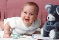 <p>William, 8 months, shows off his new teeth during playtime at Kensington Palace. </p>