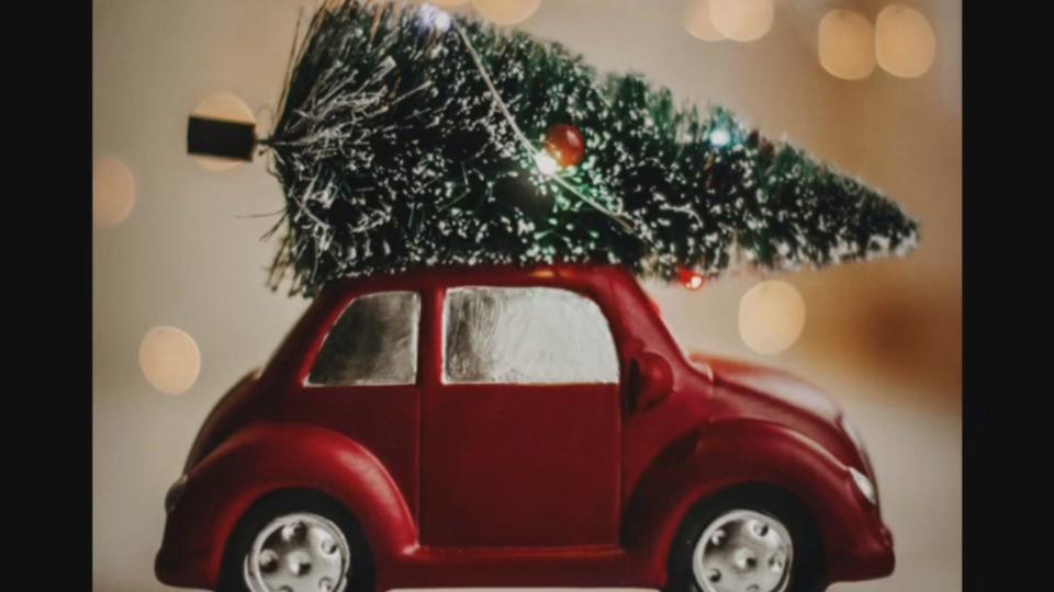 A toy car with a Christmas tree on top