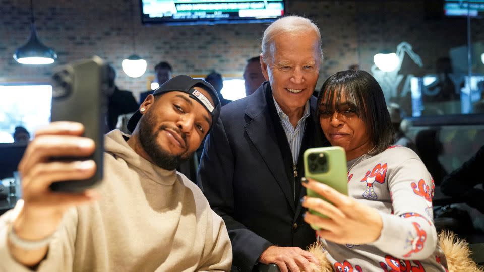 President Joe Biden poses for a selfie with diners at They Say restaurant in Detroit on Thursday. - Kevin Lamarque/Retuers