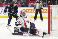 Washington Capitals goaltender Charlie Lindgren (79) makes a save as Toronto Maple Leafs forward Nicholas Robertson (89) watches during the second period of an NHL hockey game Thursday, March 28, 2024, in Toronto. (Nathan Denette/The Canadian Press via AP)