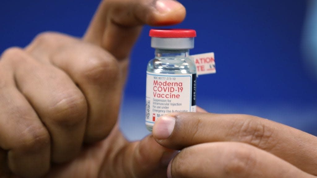 A bottle of the Moderna COVID-19 vaccine is shown Wednesday during a press conference in Fort Lauderdale, Florida. Broward Health Medical Center recently began vaccinating frontline healthcare workers with the Pfizer-BioNtech COVID-19 vaccine and are continuing to inoculate caregivers with both of them. (Photo by Joe Raedle/Getty Images)