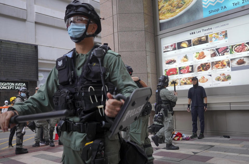 In this July. 1, 2020, file photo, police officers detain protesters during the annual handover march in Hong Kong, A national security law enacted in 2020 and COVID-19 restrictions have stifled major protests in Hong Kong including an annual march on July 1. (AP Photo/Vincent Yu, File)