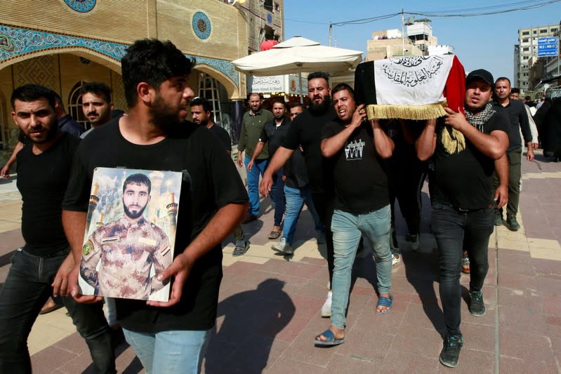 Mourners carry the coffin of a protester, who was killed at protests in Baghdad, during a funeral in the holy city of Najaf