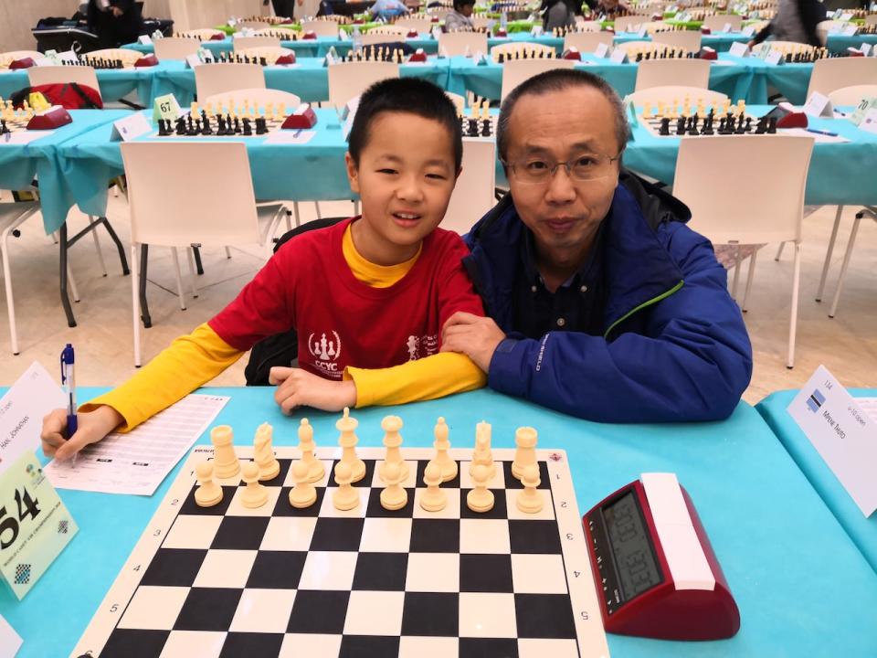 Johnathan Han and his dad Murphy travel together to chess tournaments around the world. The pair are pictured here at a competition Johnathan attended in Spain when he was 9.