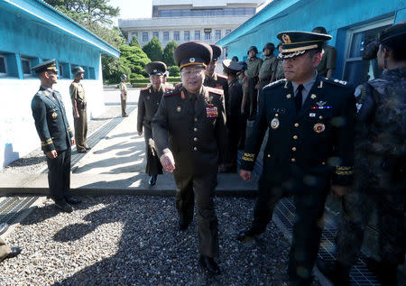 North Korean Lieutenant General An Ik San crosses the concrete border to attend a meeting at the Peace House of the border village of Panmunjom, South Korea, July 31, 2018. Yonhap via REUTERS