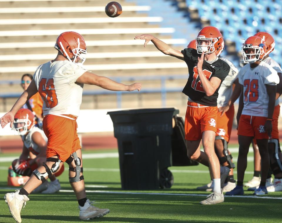 San Angelo Central High School quarterback Tyler Hill, 12, fires a pass during the first preseason practice at San Angelo Stadium on Monday, Aug. 8, 2022.