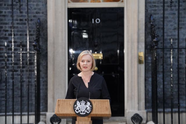 Prime Minister Liz Truss, dressed in black, reads a statement outside 10 Downing Street following the death of the Queen