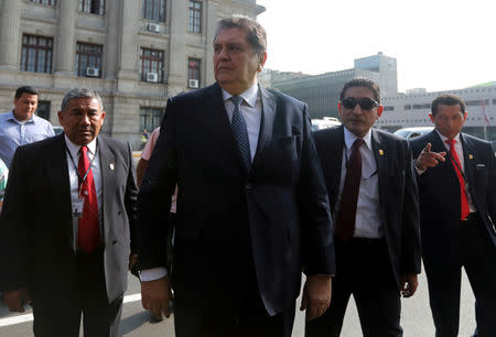 FILE PHOTO: Former Peruvian president Alan Garcia talks to the media as he arrives at the National Prosecution office in Lima, Peru March 27, 2018. REUTERS/Guadalupe Pardo/File photo