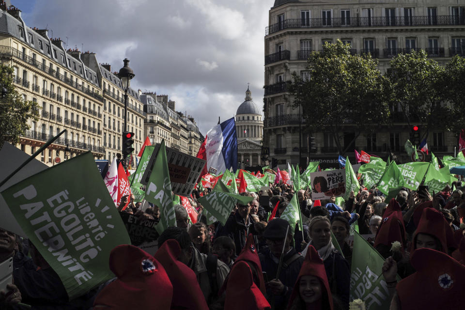 Conservative activists gather to protest in Paris, Sunday Oct. 6, 2019, against a French bill that would give lesbian couples and single women access to in vitro fertilization and related procedures. Traditional Catholic groups and far-right activists organized Sunday's protest, arguing that it deprives children of the right to a father. (AP Photo/Rafael Yaghobzadeh)