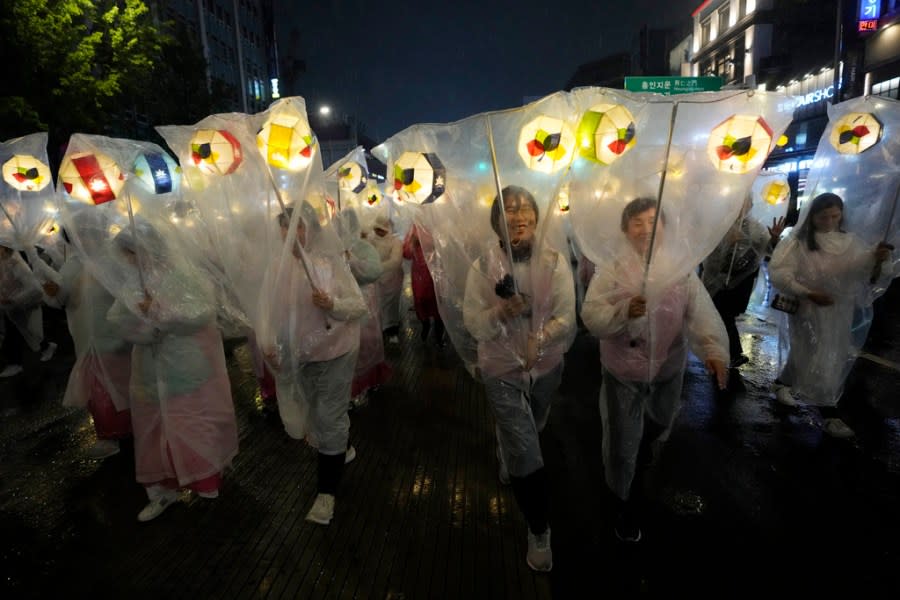 Buddhists participate in a lantern parade, wrapped in plastic sheets to protect from the rain, during the Lotus Lantern Festival, ahead of the birthday of Buddha at Dongguk University in Seoul, South Korea, Saturday, May 11, 2024. (AP Photo/Ahn Young-joon)