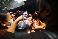 Family members comfort the daughter (C) of Ankaji Sherpa, who lost his life in an avalanche at Mount Everest last Friday, during the cremation ceremony of Nepali Sherpa climbers in Kathmandu April 21, 2014. (REUTERS/Navesh Chitrakar)