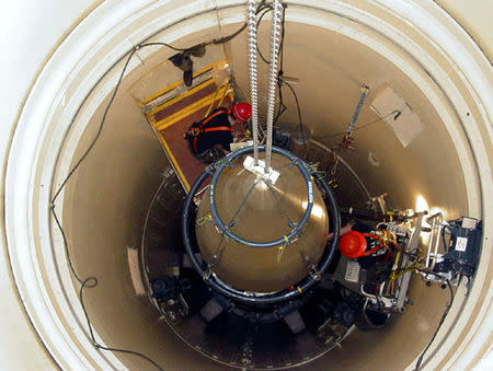 FILE PHOTO: A U.S. Air Force missile maintenance team removes the upper section of an intercontinental ballistic missile with a nuclear warhead in an undated USAF photo at Malmstrom Air Force Base, Montana, U.S.. To Match Special Report USA-NUCLEAR/ICBM U.S. Air Force/Airman John Parie/Handout via REUTERS