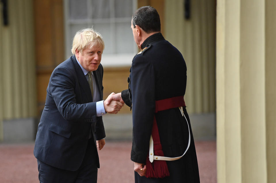 Prime Minister Boris Johnson (left) shakes hands with Queen's Equerry-in-Waiting Lieutenant Colonel Charles Richards as he leaves Buckingham Palace in London after meeting Queen Elizabeth II and accepting her invitation to form a new government after the Conservative Party was returned to power in the General Election with an increased majority.