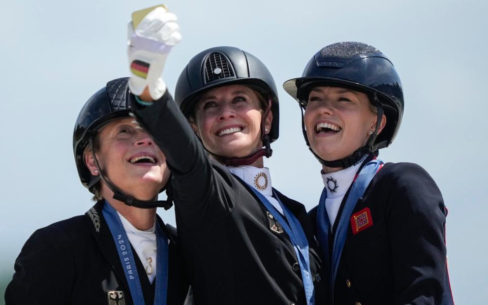 Medalists from left to right, Germany's Isabell Werth, Jessica von Bredow-Werndl and Britain's Charlotte Fry