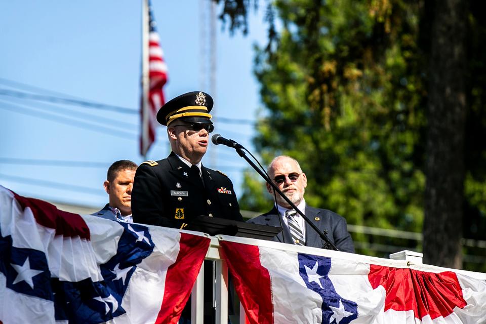 Chaplain Steven Sudduth reads an invocation during a Memorial Day ceremony, Monday, May 29, 2023, at Oakland Cemetery in Iowa City, Iowa.