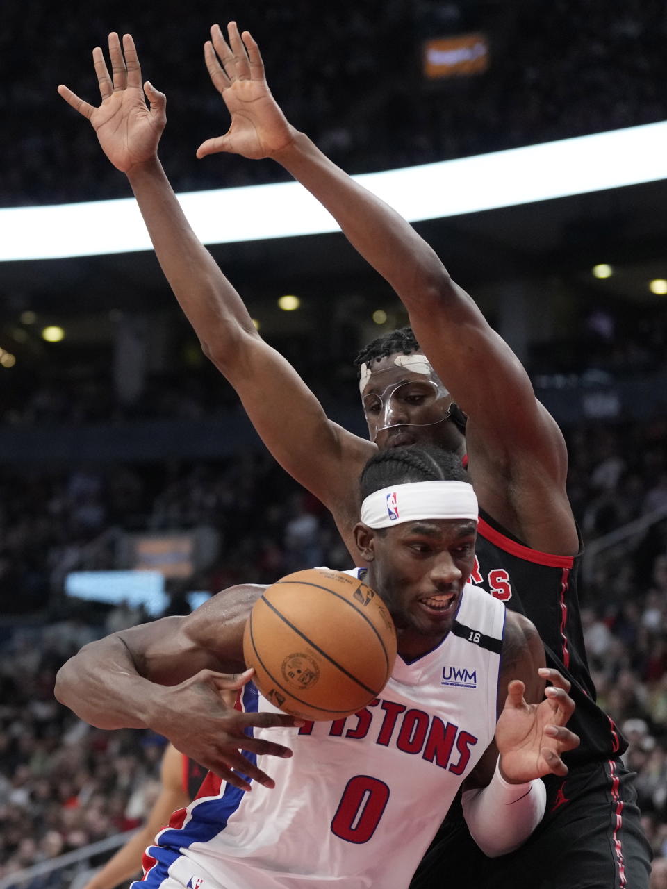 Detroit Pistons center Jalen Duren (0) moves ball as Toronto Raptors center Christian Koloko (35) defends during the second half of an NBA basketball game in Toronto, Friday, March 24, 2023. (Frank Gunn/The Canadian Press via AP)