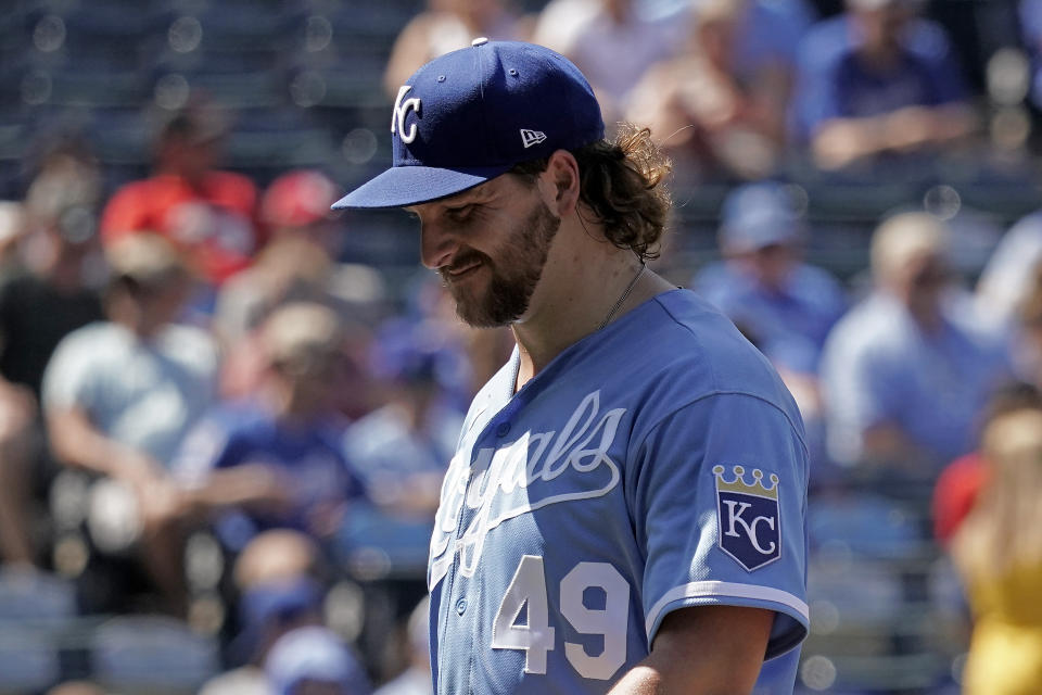 Kansas City Royals starting pitcher Jonathan Heasley walks to the dugout after coming out of the game during the second inning of a baseball game against the Cleveland Guardians Saturday, July 9, 2022, in Kansas City, Mo. (AP Photo/Charlie Riedel)