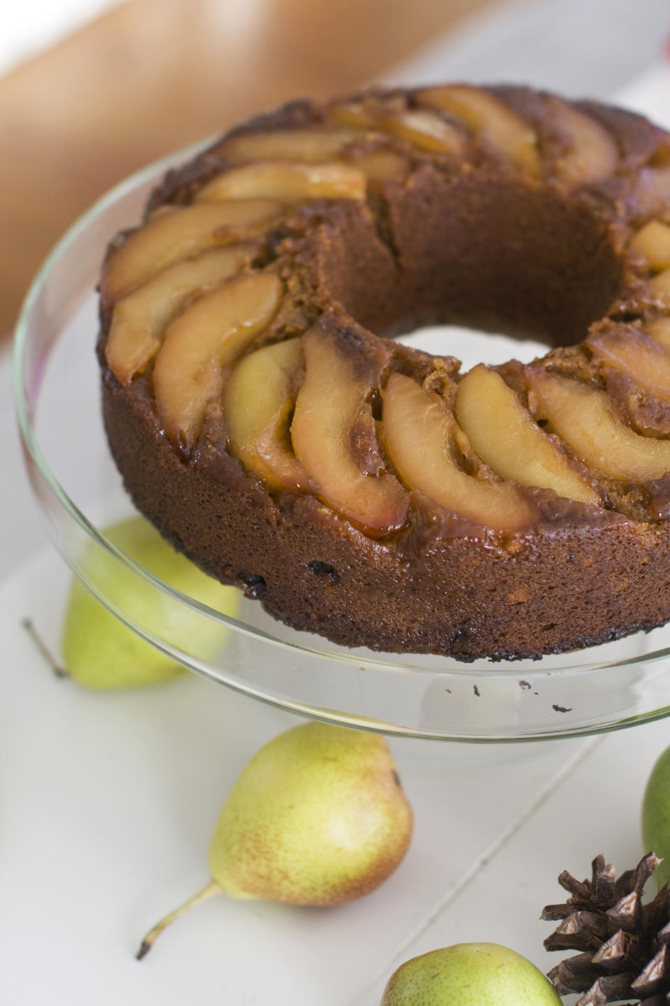 In this image taken on November 12, 2012, a lemon pear upside-down gingerbread cake is shown on a cake stand in Concord, N.H. (AP Photo/Matthew Mead)