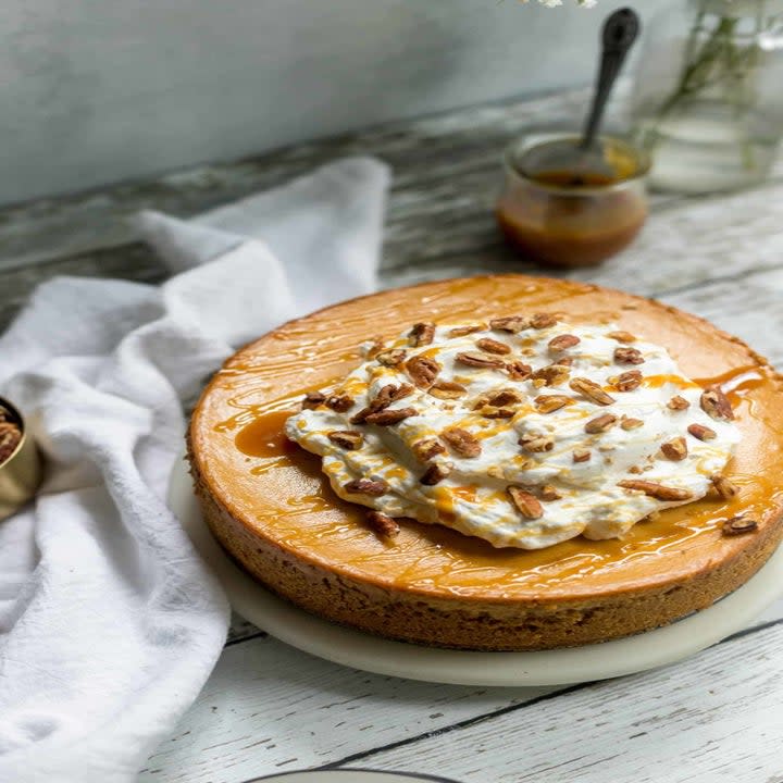 A sweet potato cheesecake with whipped cream topping.