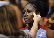 Atlanta Dream's Tiffany Hayes receives attention from a trainer after a fall during the first half of a WNBA basketball game against the Connecticut Sun in Uncasville, Conn., Wednesday, Aug. 14, 2013. (AP Photo/Jessica Hill)