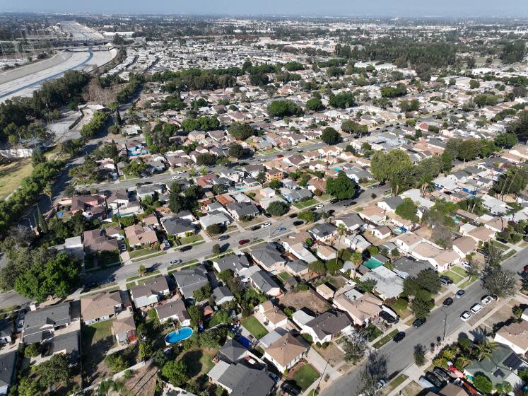 Long Beach, CA - October 05: An aerial view of the Los Angeles River west of DeForest Park in North Long Beach and the neighborhood east of the river and park in Long Beach, Wednesday, Oct. 5, 2022. A new UCI study warns that a major food would hit Los Angeles County's low-lying Black communities disproportionately hard. Working-class neighborhoods adjacent to the Los Angeles River in North Long Beach, for example, would be under six feet of water. (Allen J. Schaben / Los Angeles Times)