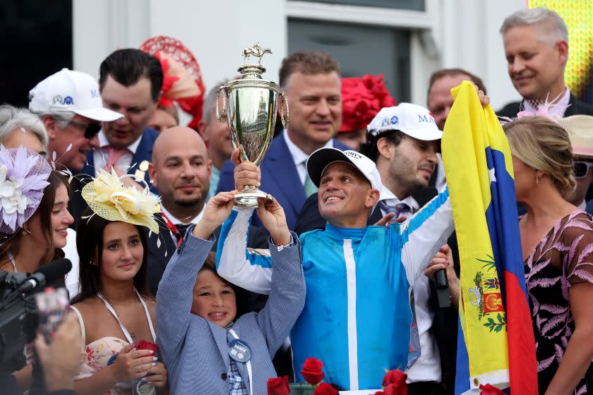 Jockey Javier Castellano celebrates in winners circle after ridding Mage to win the 149th running of the Kentucky Derby