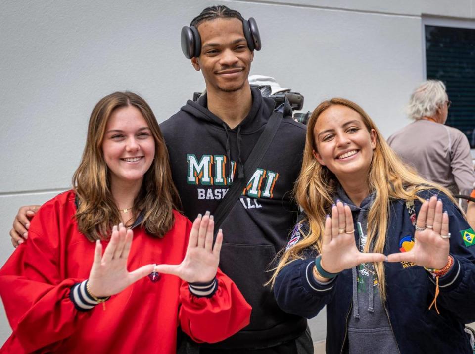 Miami, FL- March 19, 2023 - University of Miami Guard, Isaiah Wong, poses for photos with UM fans at the Watsco Center at the University of Miami. The team arrived home this afternoon after qualifying for the Sweet 16 in the NCAA Tournament.