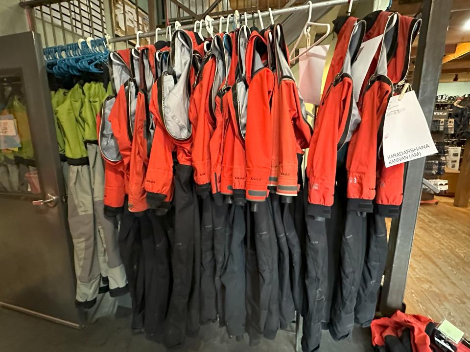 Rack of waterproof suits in rental store
