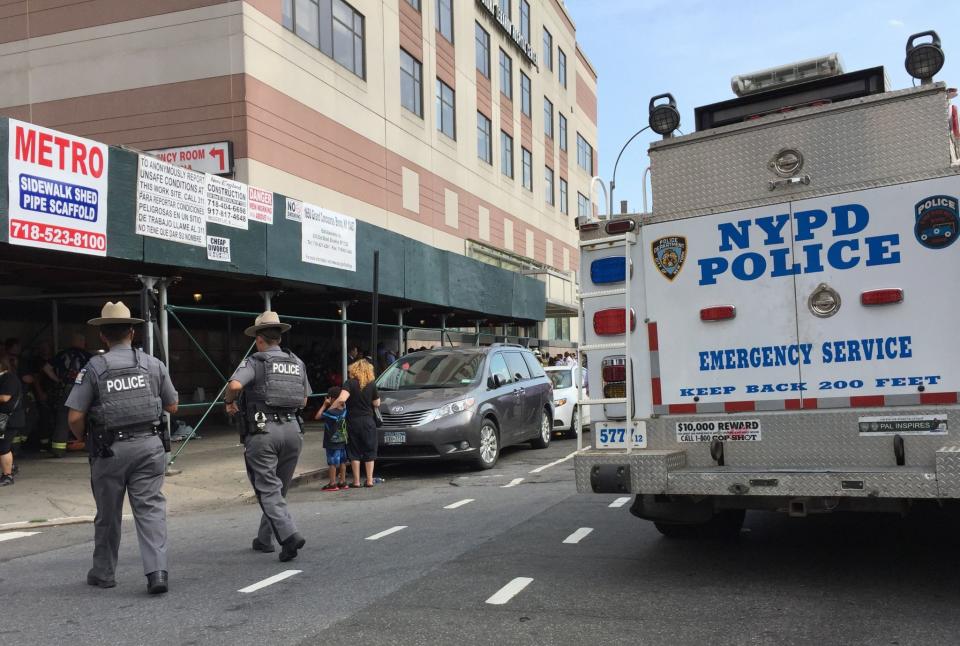 <p>Police walk past an emergency services vehicle next to Bronx-Lebanon Hospital as they respond to an active shooter north of Manhattan in New York on June 30, 2017. (Timothy A. Clary/AFP/Getty Images) </p>