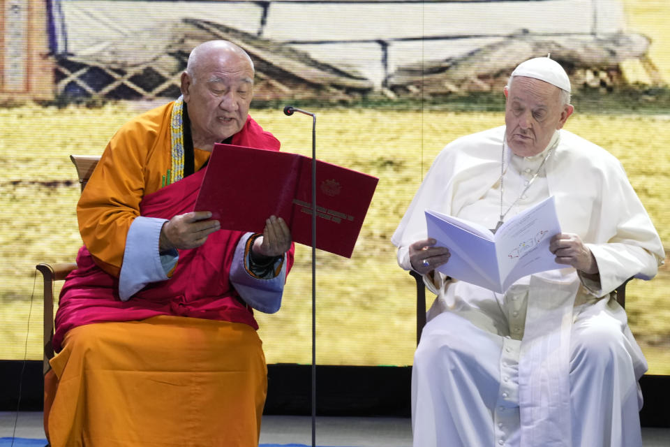 Gabju Demberel Choijamts, left, abbot of the Buddhists' Gandantegchinlen Monastery in Ulaanbaatar addresses Pope Francis during a meeting with religious leaders at the Hun Theatre in the Sky Resort compound some 15 kilometers south of the Mongolian capital Ulaanbaatar, Sunday, Sept. 3, 2023. Pope Francis has praised Mongolia's tradition of religious freedom dating to the times of founder Genghis Khan during the first-ever papal visit to the Asian nation. (AP Photo/Andrew Medichini)