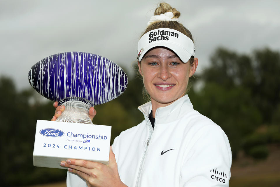 Nelly Korda smiles as she poses for photographs with the trophy after winning the PGA Ford Championship golf tournament Sunday, March 31, 2024, in Gilbert, Ariz. (AP Photo/Ross D. Franklin)