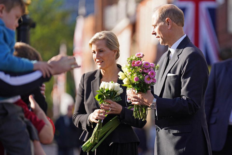 Britain's Prince Edward (R), Earl of Wessex, and Britain's Sophie (2nd R), Countess of Wessex, receive flowers from members of the public at Windsor Castle on September 16, 2022, following the death of Britain's Queen Elizabeth II on September 8.