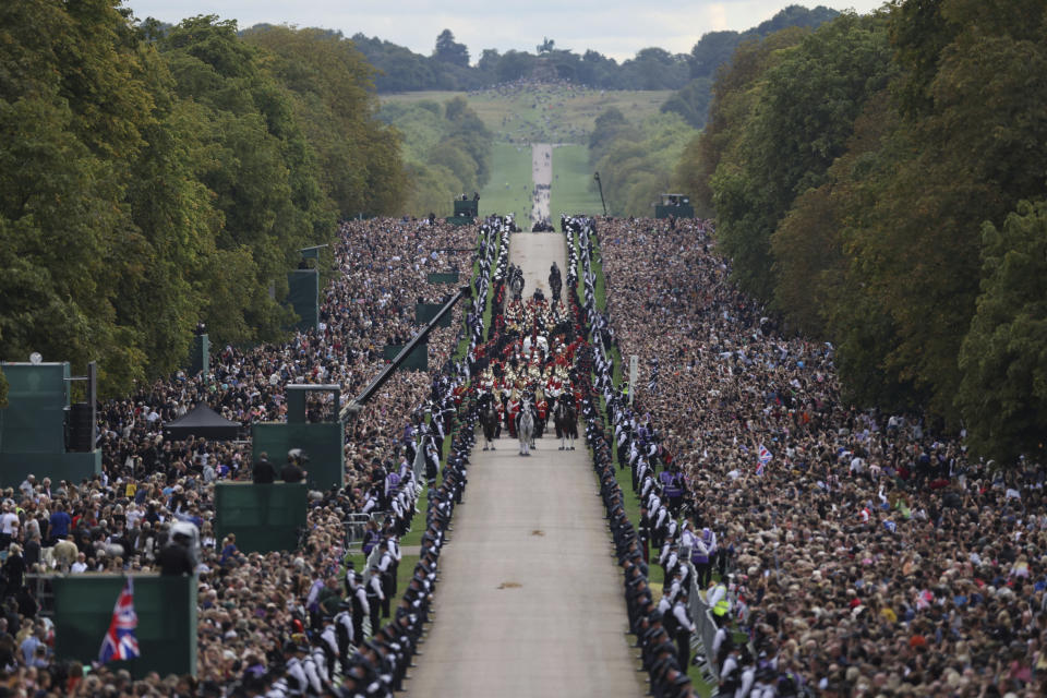 The hearse travels along the Long Walk as it makes its way to Windsor Castle, on the day of the state funeral and burial of Britain's Queen Elizabeth, in Windsor, Britain, Monday Sept. 19, 2022. The Queen, who died aged 96 on Sept. 8, will be buried at Windsor alongside her late husband, Prince Philip, who died last year. (Carl Recine/Pool Photo via AP)