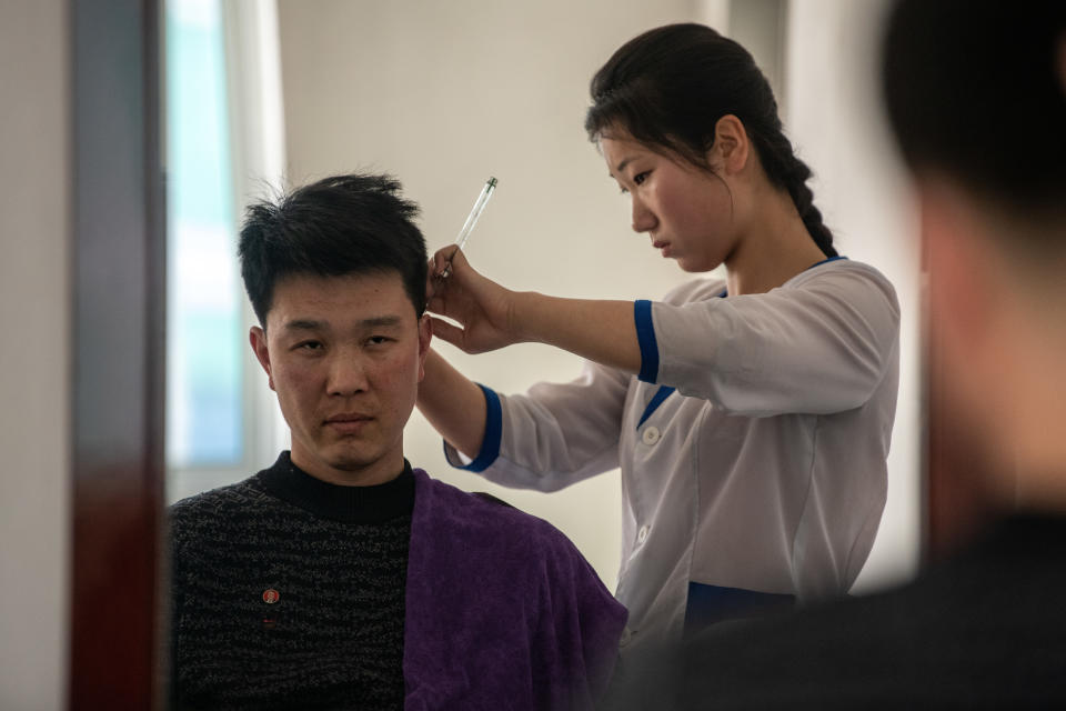 A worker has his hair cut in a salon in Hungnam Fertilizer Complex on Feb. 4, in Hamhung, North Korea.