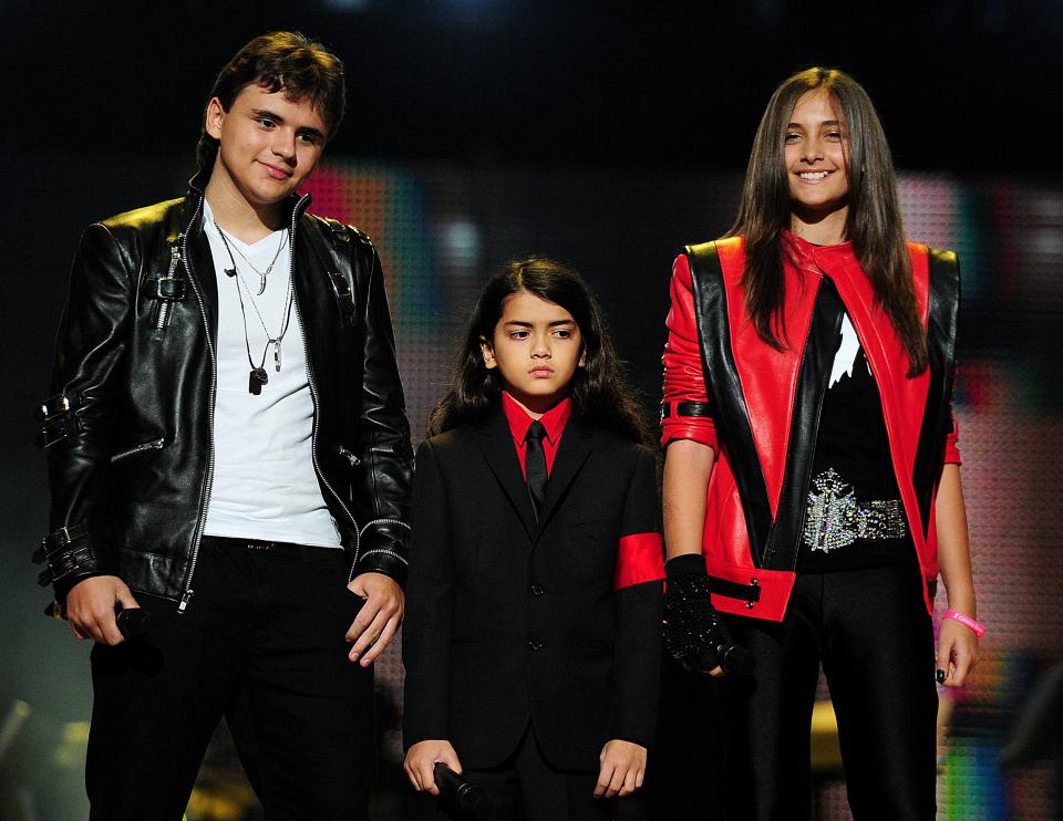 TOPSHOT - Michael Jackson's children, Prince Jackson (L), Blanket Jackson (C) and Paris Jackson (R) speak on stage during the 'Michael Forever' concert in memory of the late Michael Jackson at The Millenium Stadium in Cardiff, Wales on October 8, 2011. AFP PHOTO / LEON NEAL (Photo by LEON NEAL / AFP) (Photo by LEON NEAL/AFP via Getty Images)