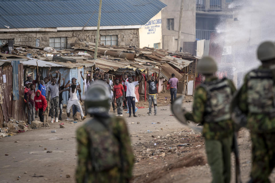 Protesters shout at police as they demonstrate in the Kibera slum of Nairobi, Kenya Monday, March 20, 2023. Hundreds of opposition supporters took to the streets of the Kenyan capital over the result of the last election and the rising cost of living, in protests organized by the opposition demanding that the president resigns from office. (AP Photo/Ben Curtis)