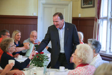 Stefan Lofven, leader of the Social Democratic Party and Prime Minister of Sweden drinks coffe and talks with citizens during election day in Sundbyberg, Sweden September 9, 2018. TT News/Soren Andersson via REUTERS