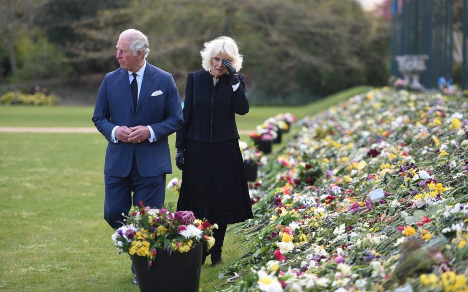 The Prince of Wales and the Duchess of Cornwall visit the gardens of Marlborough House, London, to view the flowers and messages left by members of the public outside Buckingham Palace following the death of the Duke of Edinburgh on April 10 - Jeremy Selwyn