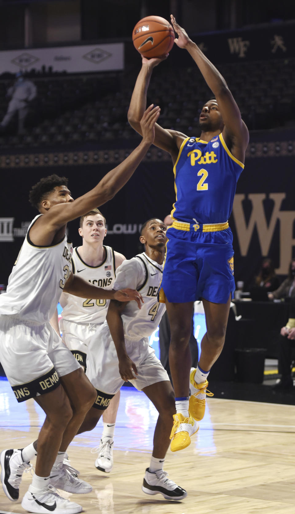 Pittsburgh's Femi Odukale (2) puts up a jumper over Wake Forest's Emmanuel Okpomo during an NCAA college basketball game Saturday, Jan. 23, 2021, in Winston-Salem, N.C. (Walt Unks/The Winston-Salem Journal via AP)