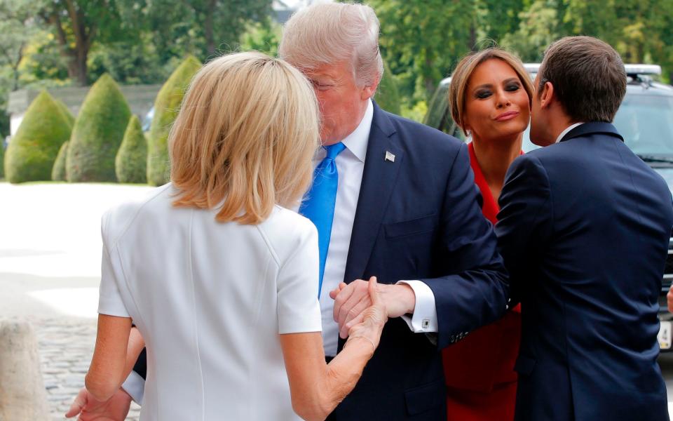 Emmanuel Macron welcomes US First Lady Melania Trump while his wife Brigitte Macron welcomes US President Donald Trump - Credit: AFP