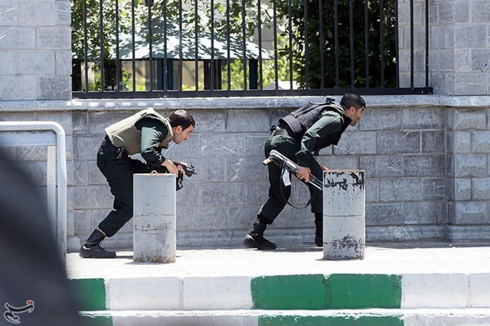 <p>Members of Iranian forces take cover during an attack on the Iranian parliament in central Tehran, Iran, June 7, 2017. (Photo: Tasnim News Agency/Handout via Reuters) </p>