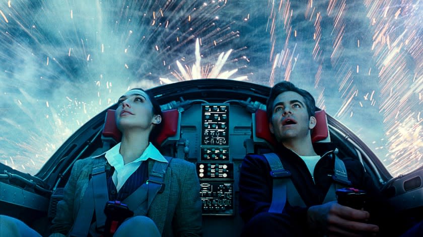 (L-r) CHRIS PINE as Steve Trevor and GAL GADOT as Wonder Woman in Warner Bros. Pictures' action adventure "WONDER WOMAN 1984," a Warner Bros. Pictures release. Photo courtesy of Warner Bros. Pictures/ ™ & © DC Comics