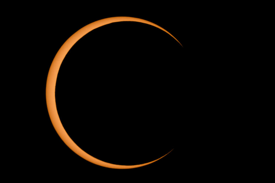 Differing from a total solar eclipse, the moon in an annular eclipse appears too small to cover the sun completely, leaving a ring of fire effect around the moon.  / Credit: RICK KERN / Getty Images